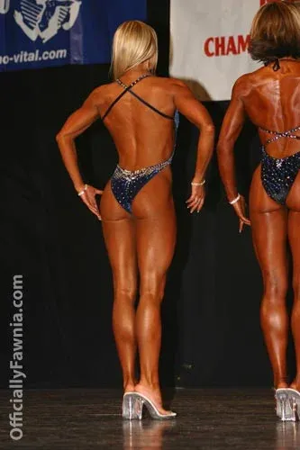 Fawnia posing on stage in a competition bikini at a fitness competition (photo 3)