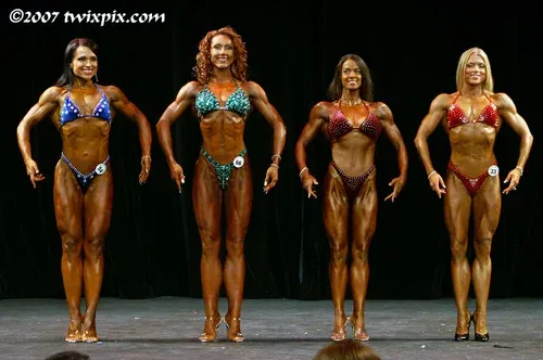 Fawnia posing on stage in a competition bikini at a fitness competition (photo 5)